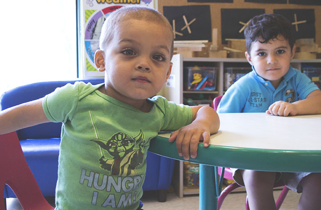 Two preschoolers sitting at a classroom table